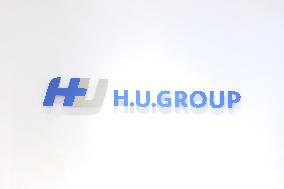 H.U. Group Holding Sign and Logo